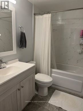 London North (North G) condo for rent - A white toilet sits next to a sink in a bathroom.