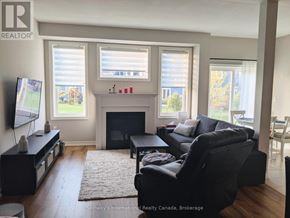Collingwood townhouse for rent - A living room with a fireplace and a flat screen TV.