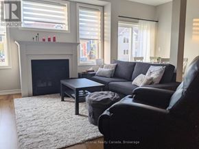 Collingwood townhouse for rent - A living room with a fireplace and a couch.