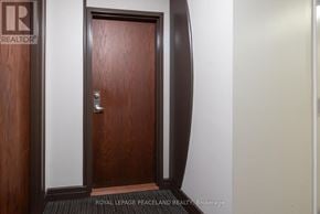Toronto (Willowdale East) condo for rent - A brown door with a silver handle is in the center of the image.
