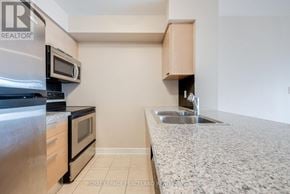 Toronto (Willowdale East) condo for rent - A kitchen with a sink and a microwave.