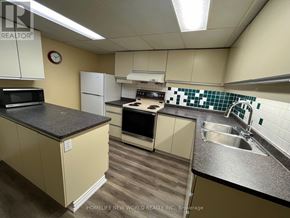Toronto (Lansing-Westgate) apartment for rent - A kitchen with a black countertop and white cabinets.