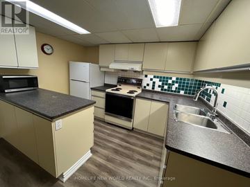 Toronto (Lansing-Westgate) apartment for rent - A kitchen with a black countertop and white cabinets.