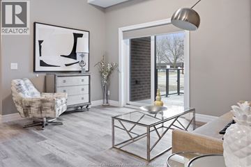 Tecumseh condo for rent - A living room with a glass coffee table and a chair.