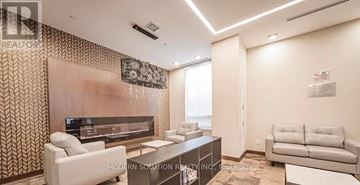 Markham (Unionville) condo for rent - A modern living room with a large television and comfortable seating.