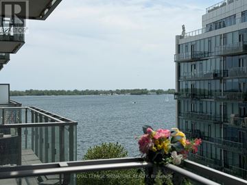 Toronto (Waterfront Communities) condo for rent - A balcony with a flower pot overlooks a body of water with boats.