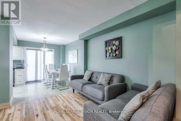 Vaughan (Maple) townhouse for rent - A living room with a grey couch and a painting on the wall.
