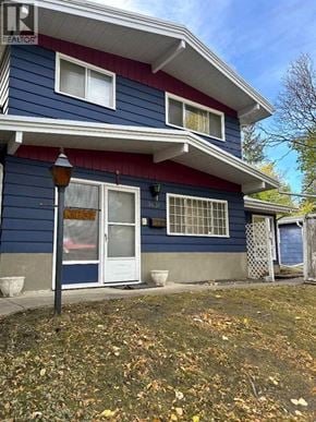 Calgary apartment for rent - A blue house with a white door and windows.