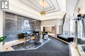 Richmond Hill (Beaver Creek Business Park) condo for rent - A well-lit, modern lobby area with a black and white marble floor, a black sofa, and a glass door.