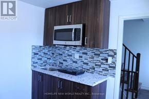 Toronto (Rockcliffe-Smythe) townhouse for rent - A kitchen with a microwave above the counter.