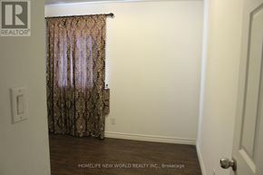 Toronto (Rockcliffe-Smythe) townhouse for rent - A room with a curtain and a door.