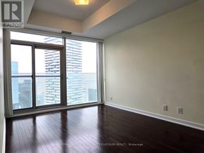 Toronto (Waterfront Communities) condo for rent - A room with a large window and wooden flooring.