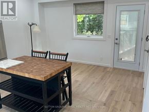 Toronto (Lambton Baby Point) apartment for rent - A room with a wooden table and chairs.