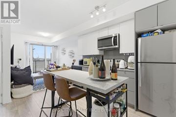 Burlington (Alton) condo for rent - A kitchen with a table and chairs in the middle of it.