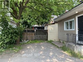 Hamilton (Crown Point) multi-family for rent - A tree is in front of a house.