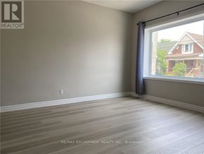 Hamilton (Crown Point) multi-family for rent - A room with a window and wooden flooring.