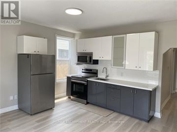 Hamilton (Crown Point) multi-family for rent - A kitchen with a refrigerator, oven, microwave, and sink.