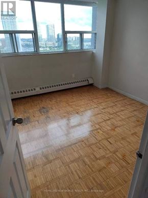 Toronto (Agincourt South-Malvern West) condo for rent - A room with a wooden floor and a window overlooking a cityscape.