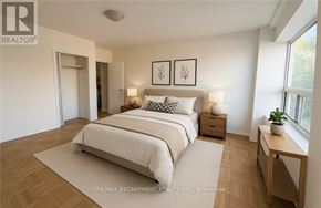 Hamilton (Durand) condo for rent - A bedroom with a large bed, two nightstands, and a window.