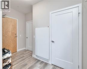 Kitchener condo for rent - A room with a white door and a wooden door.