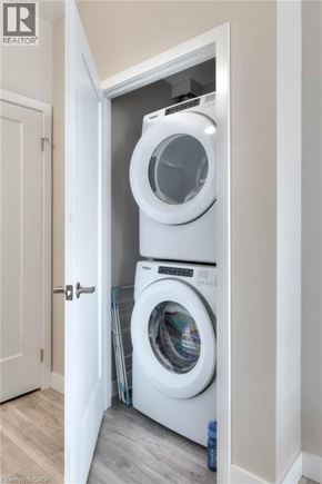 Kitchener condo for rent - A white washing machine is in a small alcove.