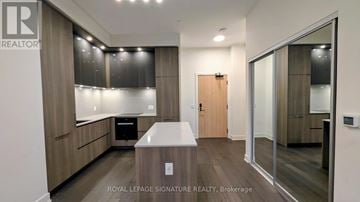 Toronto (Waterfront Communities) condo for rent - A modern kitchen with wooden cabinets and a white countertop.