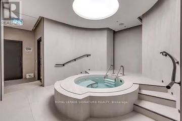 Toronto (Waterfront Communities) condo for rent - A modern bathroom with a round tub and a skylight.