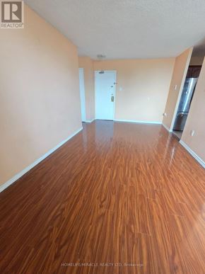 Toronto (Dorset Park) condo for rent - A room with wooden flooring and a white door.