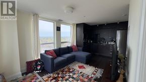 Toronto (Willowdale East) condo for rent - A living room with a couch and a television.