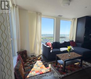 Toronto (Willowdale East) condo for rent - A living room with a couch, a chair, and a coffee table.