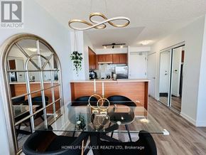 Toronto (Woburn) condo for rent - A modern dining area with a glass table and chairs.