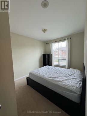 Toronto (Malvern) condo for rent - A bedroom with a bed, a window, and a television.