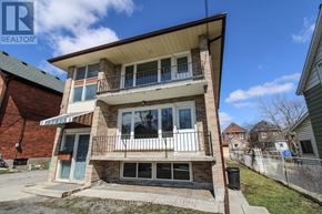 Peterborough (Town Ward 3) triplex for rent - A two-story brick house with a balcony on the second floor.