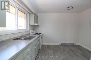 Peterborough (Town Ward 3) triplex for rent - A kitchen with a sink and a window.