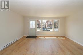 Peterborough (Town Ward 3) triplex for rent - A room with a door and a mat on the floor.
