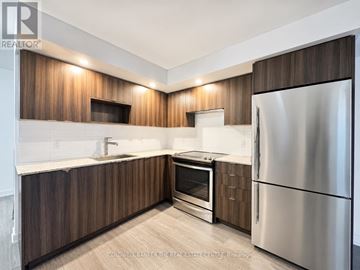 Toronto (Agincourt South-Malvern West) condo for rent - A modern kitchen with wooden cabinets and stainless steel appliances.