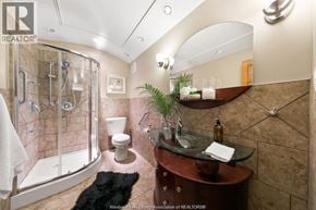 Windsor apartment for rent - A bathroom with a glass shower stall and a sink.