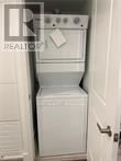 Brantford condo for rent - A white oven and dishwasher in a small kitchen.