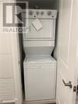 Brantford condo for rent - A white oven and dishwasher in a small kitchen.