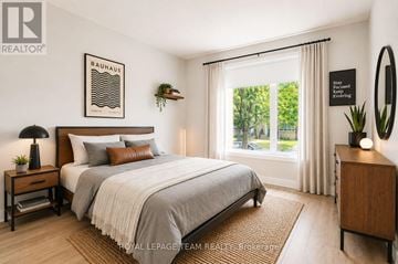 Ottawa multi-family for rent - A well-lit bedroom with a large bed and a poster on the wall.