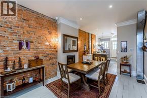 Hamilton apartment for rent - A dining room with a brick wall and a wooden table.