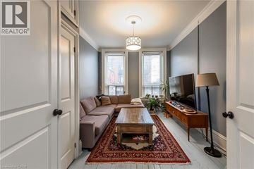 Hamilton apartment for rent - A well-lit living room with a brown sofa and a wooden coffee table.