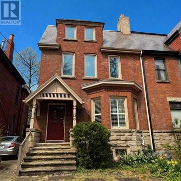 Toronto (Casa Loma) apartment for rent - A red brick house with a car parked in front.