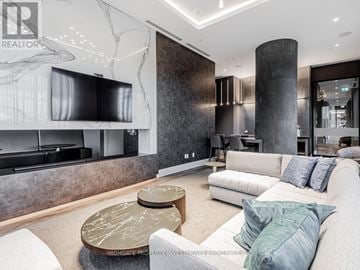 Oshawa (Windfields) condo for rent - A modern living room with a large couch and a coffee table.