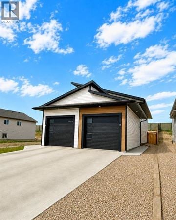 Grande Prairie apartment for rent - A two-car garage with a white and black exterior.
