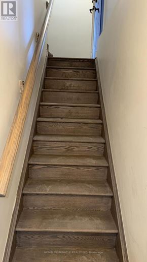 Caledon apartment for rent - A staircase with wooden steps and a light brown handrail.