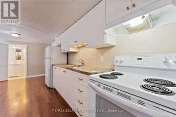 Hamilton (Berrisfield) apartment for rent - A white stove in a kitchen with white cabinets and a white counter.