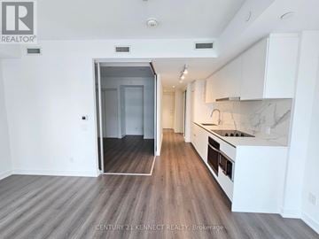 Toronto (Bay Street Corridor) condo for rent - A spacious kitchen with white cabinets and a marble countertop.