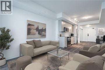 Burlington condo for rent - A living room with a couch, a coffee table, and a painting on the wall.