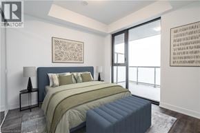 Burlington condo for rent - A bedroom with a large bed and a painting on the wall.